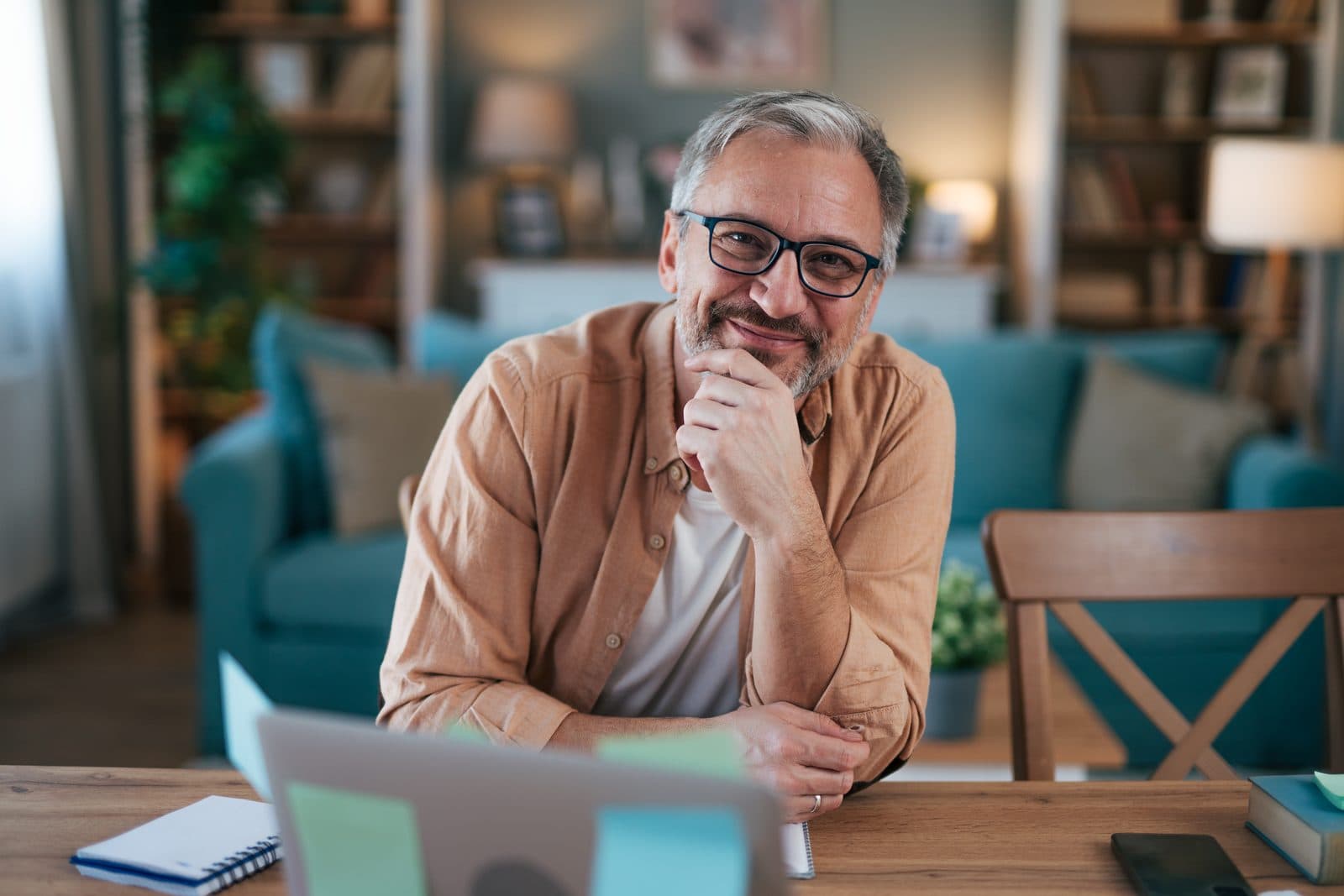 A person at a home desk with a laptop, in the kind of everyday moment when a money question shows up.
